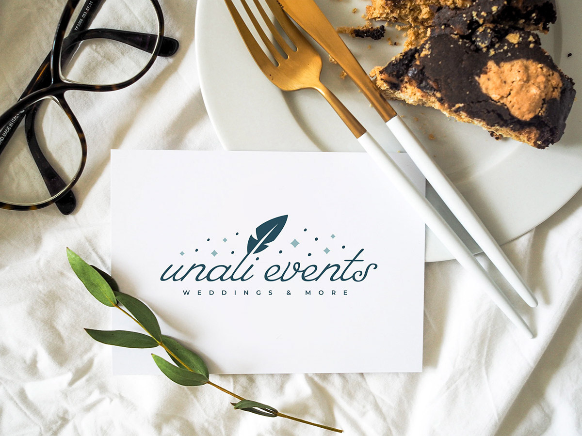 Unali Events logo on card in formal dining setting